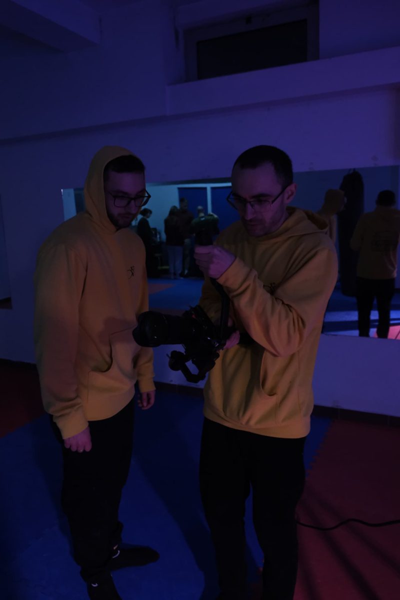 Two operators balancing a gimbal rig before a take