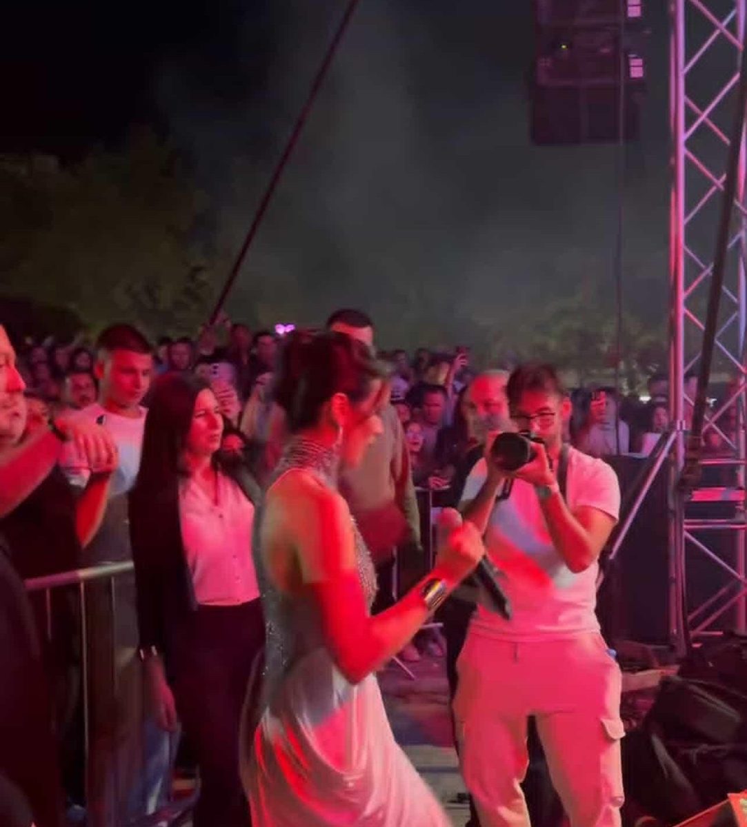 Filming a singer up close in front of the crowd