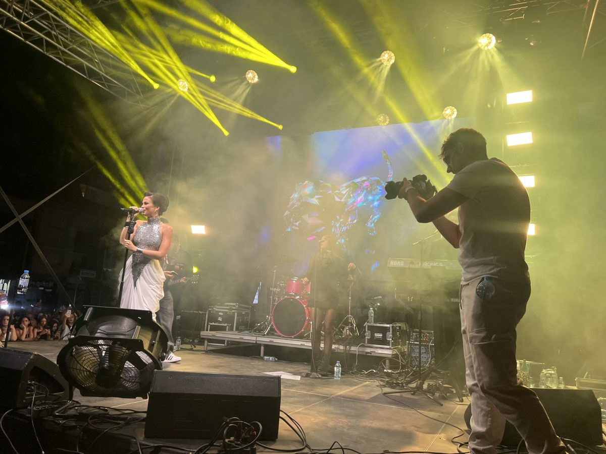 Camera operator covering a live show in stage haze